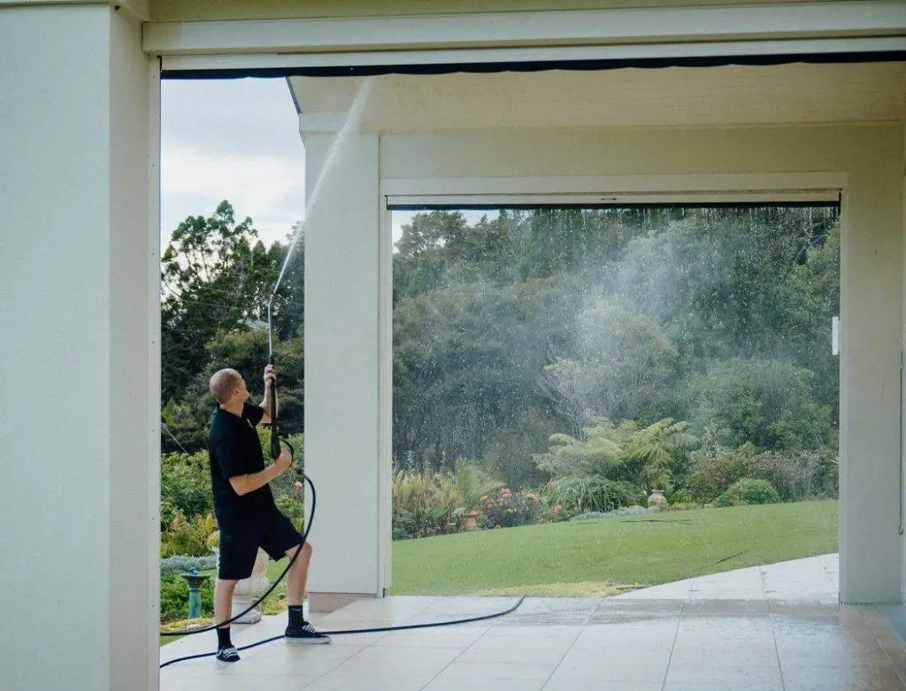 Connect Property Services team performing professional water blasting on the exterior of a home in Warkworth, removing dirt, mold, and grime with high-pressure cleaning. Expert house washing and pressure washing services in Auckland and North Shore, ensuring a clean and well-maintained property.